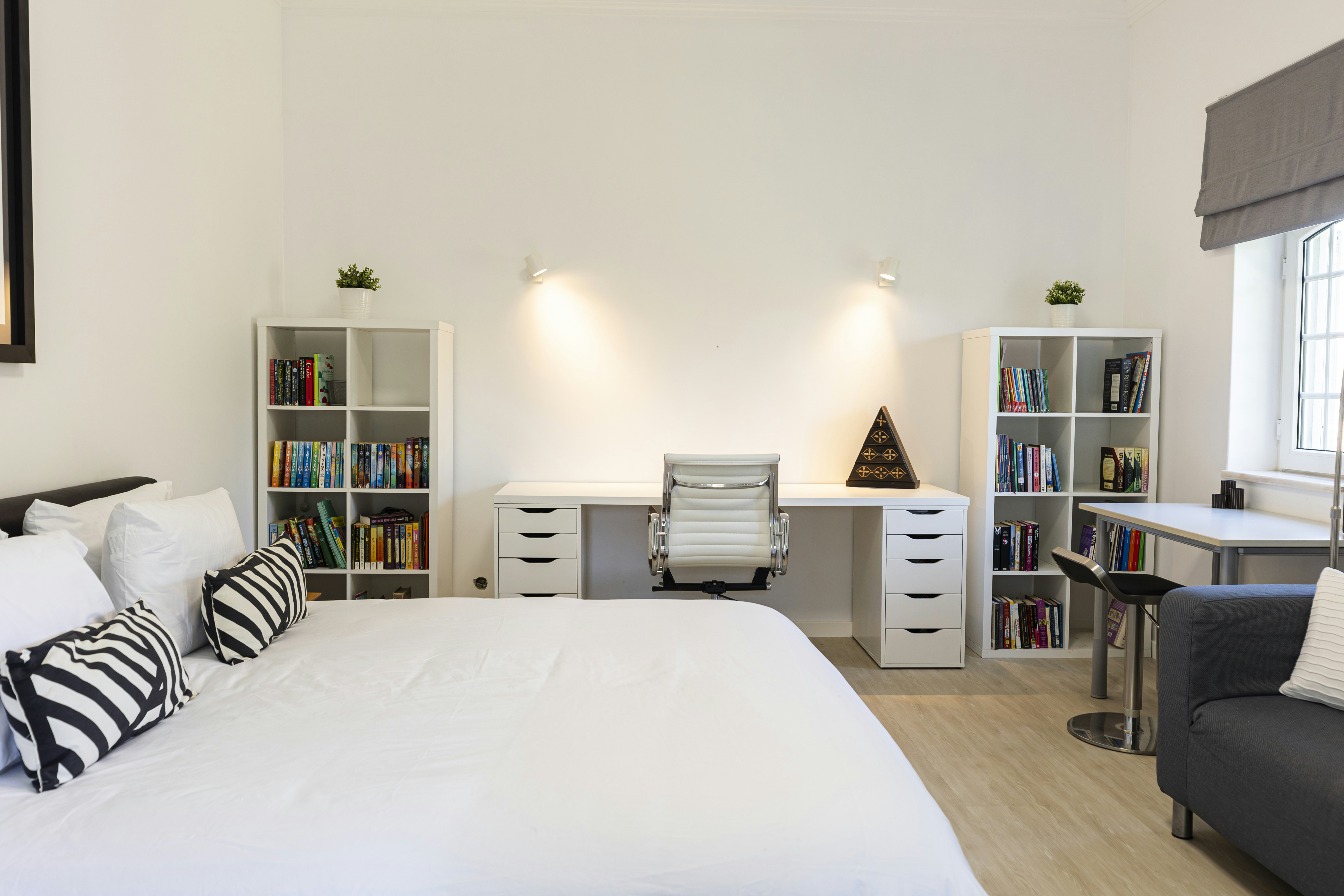A cozy bedroom with a built-in workspace.